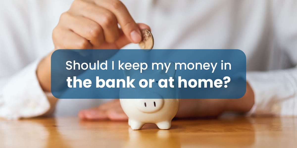 man's hand saving coins in a piggy bank